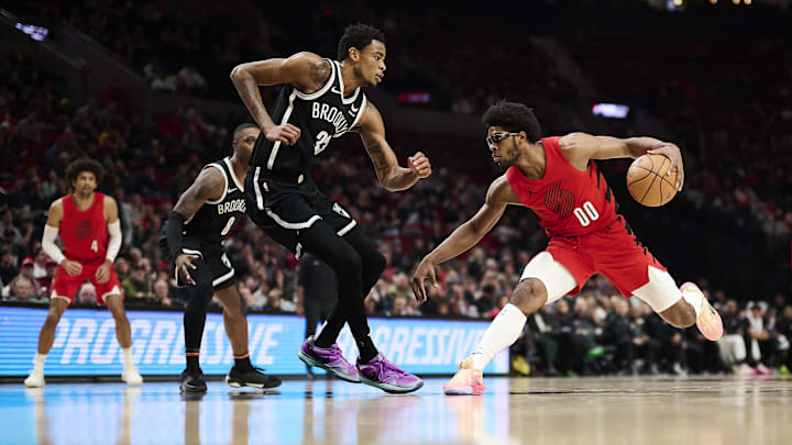 Jan 17, 2024; Portland, Oregon, USA; Portland Trail Blazers guard Scoot Henderson (00) drives to the basket during the second half against Brooklyn Nets center Nic Claxton (33) at Moda Center. Mandatory Credit: Troy Wayrynen-Imagn Images