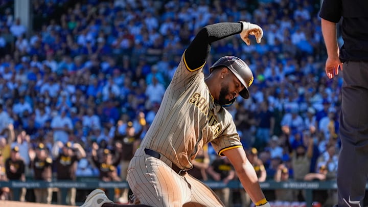 Sep 30, 2025; Chicago, Illinois, USA; San Diego Padres shortstop Xander Bogaerts (2) slides safely into third base after a throwing error made by the Chicago Cubs in the second inning during game one of the Wildcard round for the 2025 MLB playoffs at Wrigley Field. Mandatory Credit: David Banks-Imagn Images