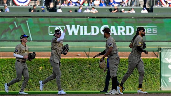 Oct 1, 2025; Chicago, Illinois, USA; San Diego Padres outfielders celebrate after the final out for the win against the Chicago Cubs in the ninth inning during game two of the Wildcard round for the 2025 MLB playoffs at Wrigley Field. Mandatory Credit: Matt Marton-Imagn Images Oct 1, 2025; Chicago, Illinois, USA; San Diego Padres outfielders celebrate after the final out for the win against the Chicago Cubs in the ninth inning during game two of the Wildcard round for the 2025 MLB playoffs at Wrigley Field. Mandatory Credit: Matt Marton-Imagn Images
