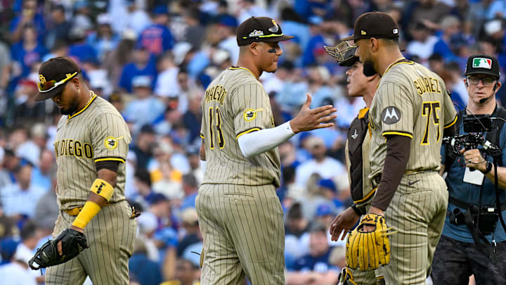 Oct 1, 2025; Chicago, Illinois, USA; San Diego Padres relief pitcher Robert Suarez (75) celebrates with teammates after the final out for the win against the Chicago Cubs in the ninth inning during game two of the Wildcard round for the 2025 MLB playoffs at Wrigley Field. Mandatory Credit: Matt Marton-Imagn Images