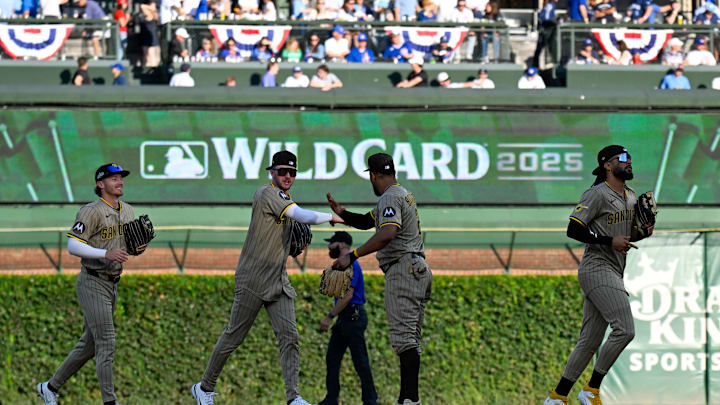 Oct 1, 2025; Chicago, Illinois, USA; San Diego Padres outfielders celebrate after the final out for the win against the Chicago Cubs in the ninth inning during game two of the Wildcard round for the 2025 MLB playoffs at Wrigley Field. 