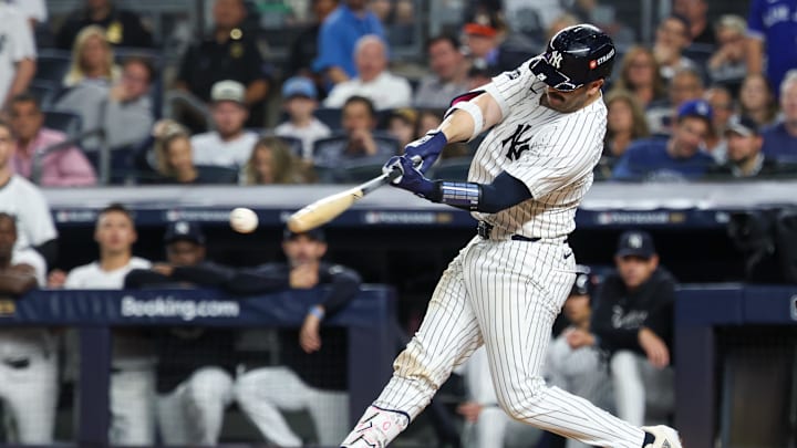 Oct 7, 2025; Bronx, New York, USA; New York Yankees catcher Austin Wells (28) hits an RBI single against the Toronto Blue Jays in the fifth inning during game three of the ALDS round for the 2025 MLB playoffs at Yankee Stadium. Mandatory Credit: Vincent Carchietta-Imagn Images