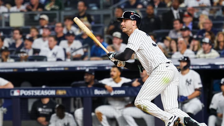 Oct 7, 2025; Bronx, New York, USA; New York Yankees outfielder Cody Bellinger (35) hits a single in the third inning against the Toronto Blue Jays during game three of the ALDS round for the 2025 MLB playoffs at Yankee Stadium. Mandatory Credit: Vincent Carchietta-Imagn Images