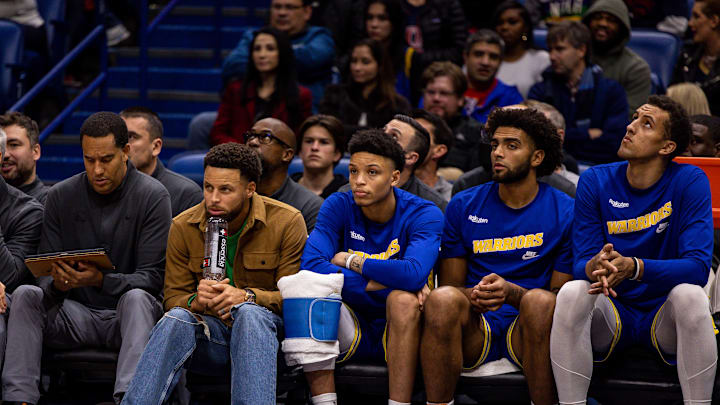 Nov 21, 2022; New Orleans, Louisiana, USA;  Golden State Warriors forward Anthony Lamb (40) and guard Ryan Rollins (2) and forward Anthony Lamb (40) and forward Patrick Baldwin Jr. (7) looks on from the bench against the New Orleans Pelicans during the second half at Smoothie King Center. Mandatory Credit: Stephen Lew-Imagn Images