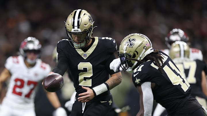 Oct 26, 2025; New Orleans, Louisiana, USA; New Orleans Saints quarterback Spencer Rattler (2) hands the ball off to running back Alvin Kamara (41) during the second quarter against the Tampa Bay Buccaneers at Caesars Superdome. Mandatory Credit: Stephen Lew-Imagn Images
