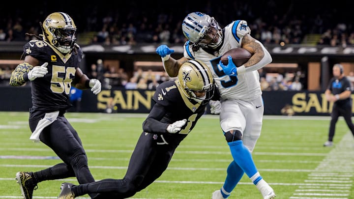 Dec 14, 2025; New Orleans, Louisiana, USA; Carolina Panthers running back Rico Dowdle (5) is hit by New Orleans Saints cornerback Alontae Taylor (1) during the second quarter at Caesars Superdome. Mandatory Credit: Stephen Lew-Imagn Images Dec 14, 2025; New Orleans, Louisiana, USA; Carolina Panthers running back Rico Dowdle (5) is hit by New Orleans Saints cornerback Alontae Taylor (1) during the second quarter at Caesars Superdome. Mandatory Credit: Stephen Lew-Imagn Images