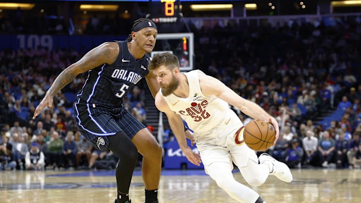 Cleveland Cavaliers forward Dean Wade drives to the basket as Orlando Magic forward Paolo Banchero.
