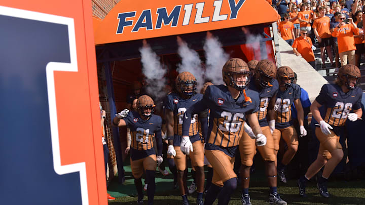 Oct 19, 2024; Champaign, Illinois, USA;  Illinois Fighting Illini players take the field before a game against the Michigan Wolverines at Memorial Stadium. Mandatory Credit: Ron Johnson-Imagn Images