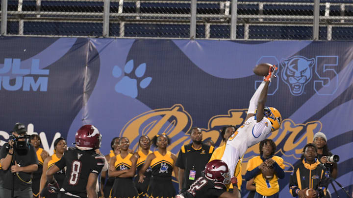 Miami Northwestern's Calvin Russell Jr. leaps for a tough catch attempt during the first half of the Class 3A state championship on Dec. 14, 2024.