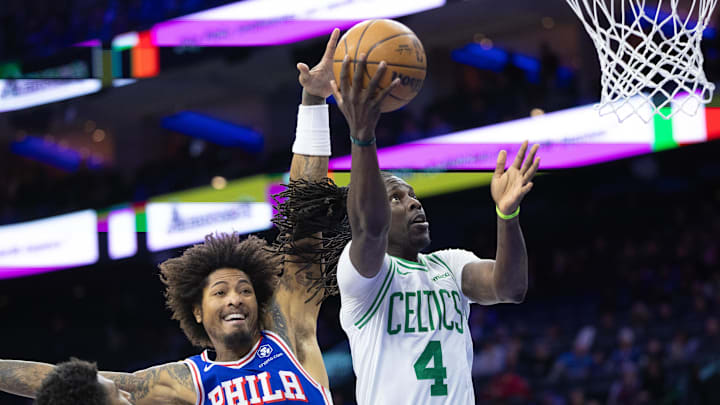 Feb 20, 2025; Philadelphia, Pennsylvania, USA; Boston Celtics guard Jrue Holiday (4) drives for a shot past Philadelphia 76ers guard Kelly Oubre Jr. (9) during the first quarter at Wells Fargo Center. Mandatory Credit: Bill Streicher-Imagn Images