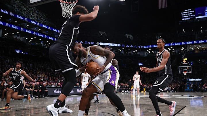Mar 31, 2024; Brooklyn, New York, USA; Los Angeles Lakers forward LeBron James (23) drives to the basket against Brooklyn Nets forward Cameron Johnson (2) during the second half at Barclays Center. Mandatory Credit: Vincent Carchietta-Imagn Images