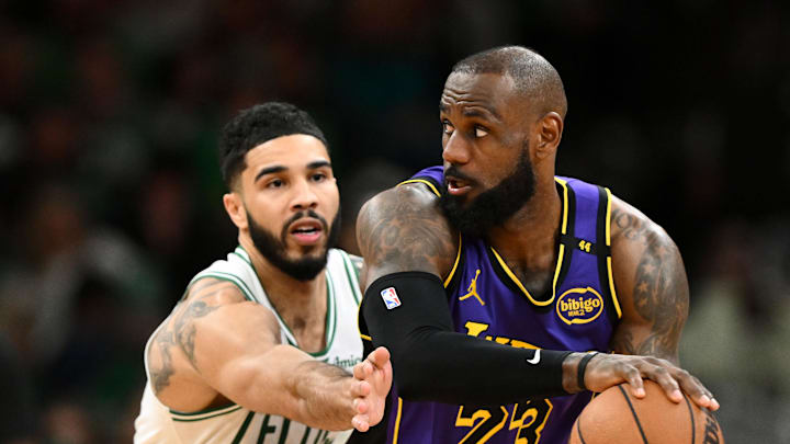 Mar 8, 2025; Boston, Massachusetts, USA; Los Angeles Lakers forward LeBron James (23) controls the ball against Boston Celtics forward Jayson Tatum (0) during the fourth quarter at the TD Garden. Mandatory Credit: Brian Fluharty-Imagn Images