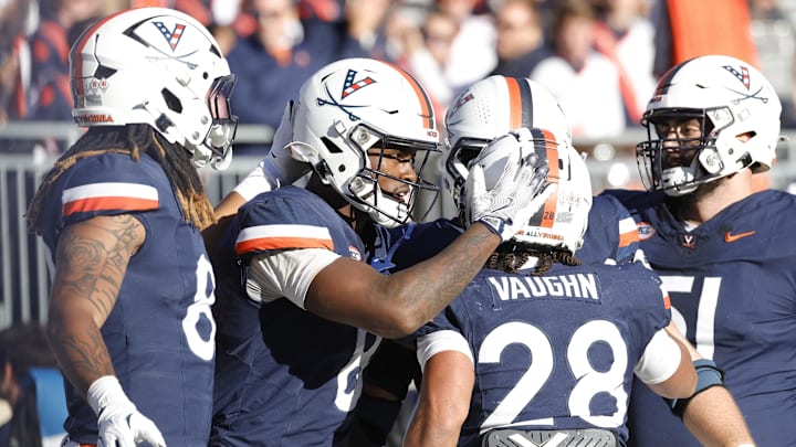 Nov 23, 2024; Charlottesville, Virginia, USA; Virginia Cavaliers wide receiver Malachi Fields (8) celebrates with teammates after scoring a touchdown against the Southern Methodist Mustangs during the second half at Scott Stadium. Mandatory Credit: Amber Searls-Imagn Images Nov 23, 2024; Charlottesville, Virginia, USA; Virginia Cavaliers wide receiver Malachi Fields (8) celebrates with teammates after scoring a touchdown against the Southern Methodist Mustangs during the second half at Scott Stadium. Mandatory Credit: Amber Searls-Imagn Images