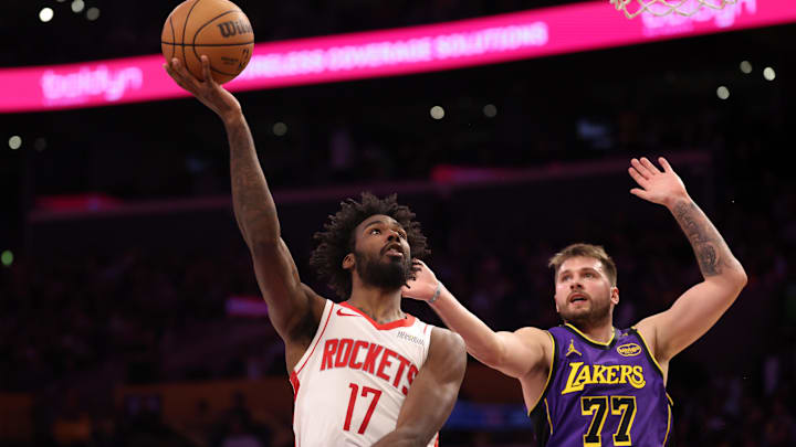 Houston Rockets forward Tari Eason shoots the ball around Los Angeles Lakers guard Luka Doncic.