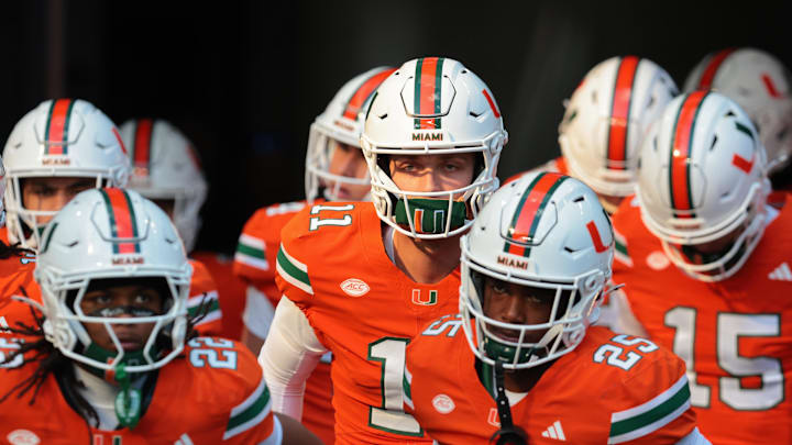 Nov 15, 2025; Miami Gardens, Florida, USA; Miami Hurricanes quarterback Carson Beck (center) enters the field to warm up before the game against NC State Wolfpack at Hard Rock Stadium. Mandatory Credit: Sam Navarro-Imagn Images Nov 15, 2025; Miami Gardens, Florida, USA; Miami Hurricanes quarterback Carson Beck (center) enters the field to warm up before the game against NC State Wolfpack at Hard Rock Stadium. Mandatory Credit: Sam Navarro-Imagn Images