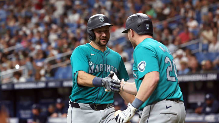 Seattle Mariners catcher Cal Raleigh (29) is congratulated by  outfielder Luke Raley (20) after he hit a home run against the Tampa Bay Rays during the fourth inning at Tropicana Field on June 24.
