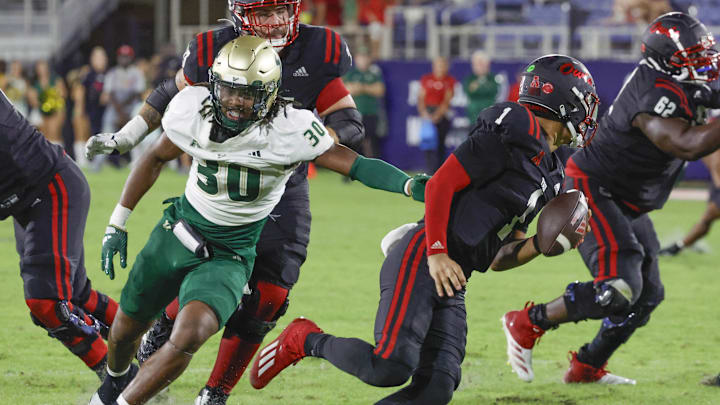 USF defensive end Ira Singleton (30) chases Florida Atlantic quarterback Cam Fancher in a win that helped the Bulls stay in the hunt for a bowl bid 