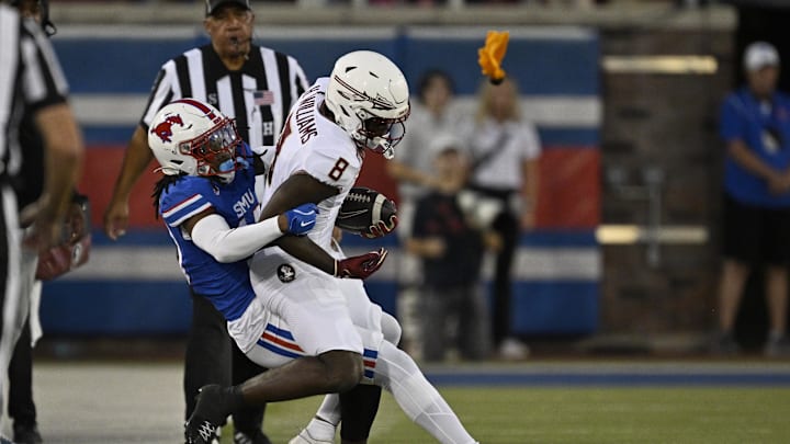 Sep 28, 2024; Dallas, Texas, USA; Southern Methodist Mustangs cornerback Jaelyn Davis-Robinson (13) and Florida State Seminoles wide receiver Hykeem Williams (8) in action during the game between the Southern Methodist Mustangs and the Florida State Seminoles at Gerald J. Ford Stadium. Mandatory Credit: Jerome Miron-Imagn Images