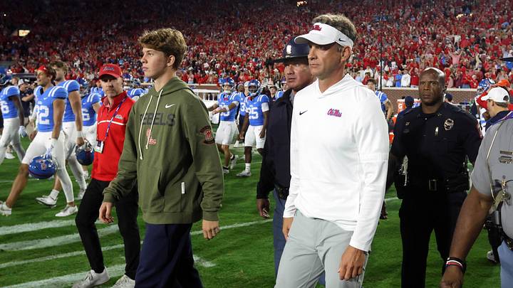 Nov 15, 2025; Oxford, Mississippi, USA; Mississippi Rebels head coach Lane Kiffin and his son, Knox Kiffin, walk onto the field after defeating the Florida Gators at Vaught-Hemingway Stadium. Mandatory Credit: Petre Thomas-Imagn Images Nov 15, 2025; Oxford, Mississippi, USA; Mississippi Rebels head coach Lane Kiffin and his son, Knox Kiffin, walk onto the field after defeating the Florida Gators at Vaught-Hemingway Stadium. Mandatory Credit: Petre Thomas-Imagn Images