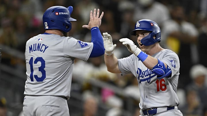 Oct 9, 2024; San Diego, California, USA; Los Angeles Dodgers catcher Will Smith (16) celebrates with third baseman Max Muncy (13) after hitting a two-run home run in the third inning against the San Diego Padres during game four of the NLDS for the 2024 MLB Playoffs at Petco Park.  Mandatory Credit: Denis Poroy-Imagn Images