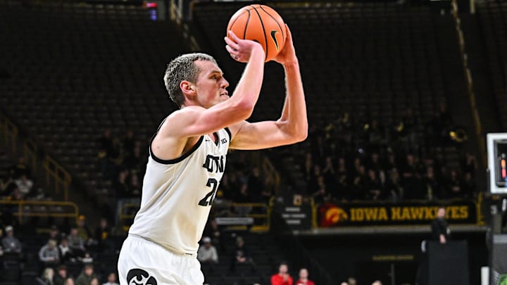 Jan 7, 2025; Iowa City, Iowa, USA; Iowa Hawkeyes forward Payton Sandfort (20) shoots a three point basket against the Nebraska Cornhuskers during the second half at Carver-Hawkeye Arena. Mandatory Credit: Jeffrey Becker-Imagn Images Jan 7, 2025; Iowa City, Iowa, USA; Iowa Hawkeyes forward Payton Sandfort (20) shoots a three point basket against the Nebraska Cornhuskers during the second half at Carver-Hawkeye Arena. Mandatory Credit: Jeffrey Becker-Imagn Images