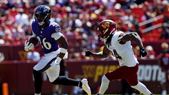 Baltimore Ravens running back Rasheen Ali runs the ball against Washington Commanders cornerback Antonio Hamilton Sr. Baltimore Ravens running back Rasheen Ali runs the ball against Washington Commanders cornerback Antonio Hamilton Sr.