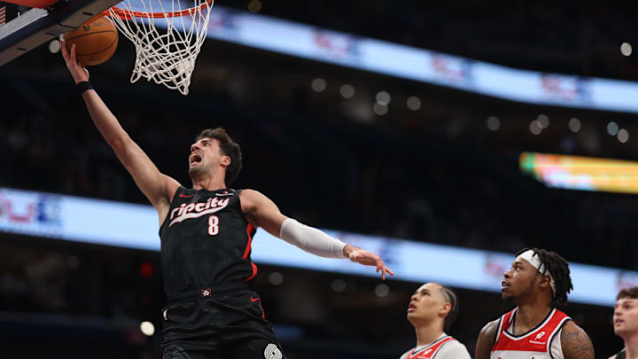 Feb 26, 2025; Washington, District of Columbia, USA;  Portland Trail Blazers forward Deni Avdija (8) shoots the ball as Washington Wizards forward Richaun Holmes (22) and Wizards forward Kyshawn George (18) look on in the first half at Capital One Arena. Mandatory Credit: Geoff Burke-Imagn Images