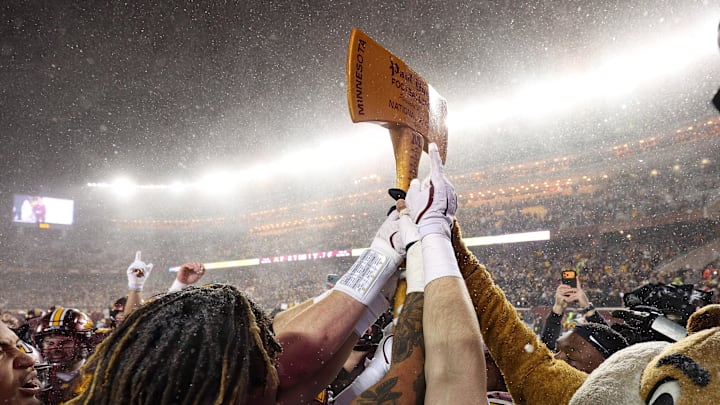 Nov 29, 2025; Minneapolis, Minnesota, USA; Minnesota Golden Gophers celebrate with Paul Bunyan’s Axe after the game against the Wisconsin Badgers at Huntington Bank Stadium. Mandatory Credit: Matt Krohn-Imagn Images