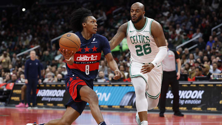 Nov 22, 2024; Washington, District of Columbia, USA; Washington Wizards guard Bub Carrington (8) drives to the basket as Boston Celtics forward Xavier Tillman (26) defends in the second half at Capital One Arena. Mandatory Credit: Geoff Burke-Imagn Images