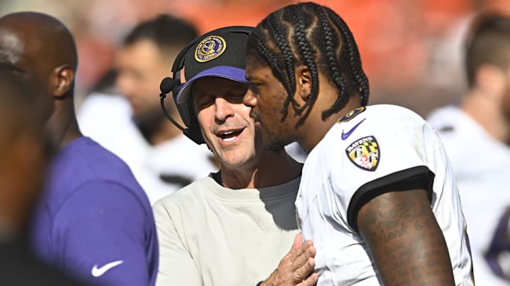 Baltimore Ravens head coach John Harbaugh talks with quarterback Lamar Jackson. Mandatory Credit: David Richard-Imagn Images