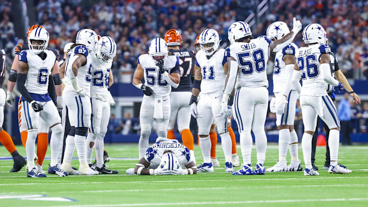 Dec 9, 2024; Arlington, Texas, USA;  Dallas Cowboys linebacker DeMarvion Overshown (13) lays injured around teammates during the second half against the Cincinnati Bengals at AT&T Stadium. Mandatory Credit: Kevin Jairaj-Imagn Images