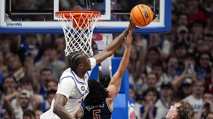 Feb 9, 2026; Lawrence, Kansas, USA; Kansas Jayhawks forward Flory Bidunga (40) blocks the shot of Arizona Wildcats guard Brayden Burries (5) during the second half at Allen Fieldhouse. Mandatory Credit: Jay Biggerstaff-Imagn Images