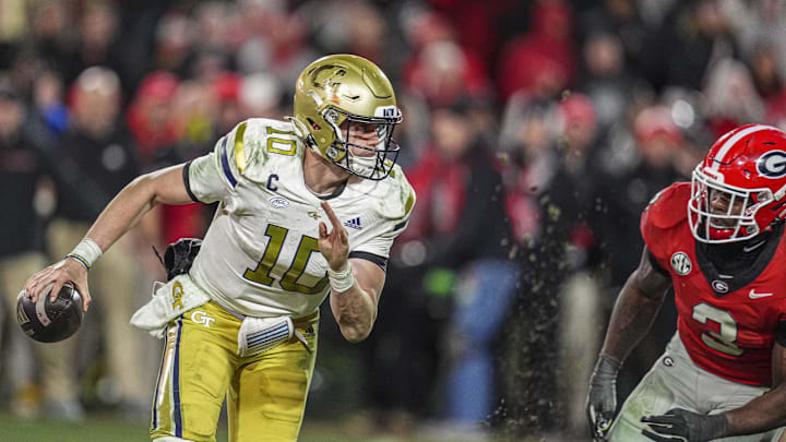 Nov 29, 2024; Athens, Georgia, USA; Georgia Tech Yellow Jackets quarterback Haynes King (10) tries to escape the rush of Georgia Bulldogs linebacker CJ Allen (3) during overtime at Sanford Stadium. Mandatory Credit: Dale Zanine-Imagn Images