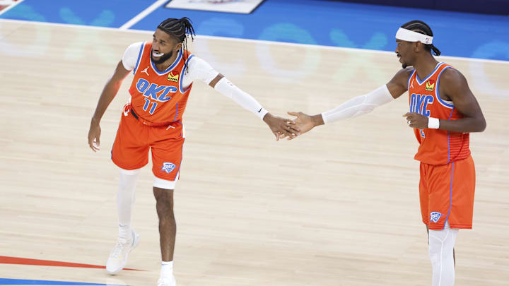 Nov 11, 2024; Oklahoma City, Oklahoma, USA; Oklahoma City Thunder guard Isaiah Joe (11) and guard Shai Gilgeous-Alexander (2) high five before the start of a game against the Los Angeles Clippers at Paycom Center. Mandatory Credit: Alonzo Adams-Imagn Images
