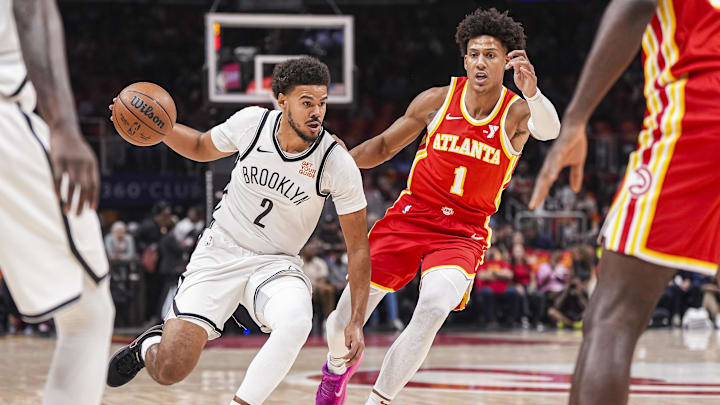 Oct 23, 2024; Atlanta, Georgia, USA; Brooklyn Nets forward Cameron Johnson (2) dribbles against Atlanta Hawks forward Jalen Johnson (1) during the first half at State Farm Arena. Mandatory Credit: Dale Zanine-Imagn Images