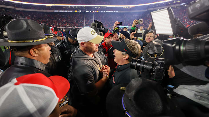 Nov 29, 2024; Athens, Georgia, USA; Georgia Tech Yellow Jackets head coach Brent Key talks to Georgia Bulldogs head coach Kirby Smart after an eight overtime game at Sanford Stadium. Mandatory Credit: Brett Davis-Imagn Images
