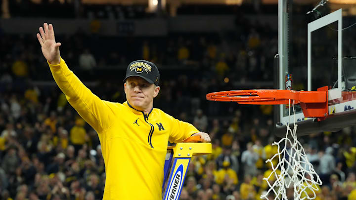 Apr 6, 2026; Indianapolis, IN, USA; Michigan Wolverines head coach Dusty May waves to the crowd as he cuts down the net after defeating the Connecticut Huskies in the national championship of the Final Four of the men's 2026 NCAA Tournament at Lucas Oil Stadium. Mandatory Credit: Robert Deutsch-Imagn Images