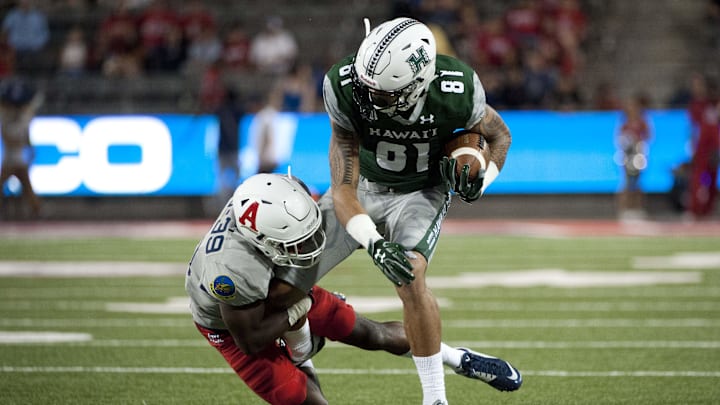 Sep 17, 2016; Tucson, AZ, USA; Hawaii Warriors wide receiver Kalakaua Timoteo (81) is tackled by Arizona Wildcats cornerback Devin Holiday (13) during the third quarter at Arizona Stadium. Mandatory Credit: Casey Sapio-Imagn Images