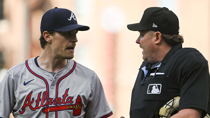 Jun 11, 2024; Baltimore, Maryland, USA;  Atlanta Braves pitcher Max Fried (54) speaks with home plate umpire Chad Whitson (62) while walking to the dugout after the first inning of the game against the Baltimore Orioles at Oriole Park at Camden Yards.