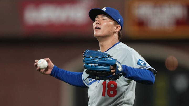 Sep 12, 2025; San Francisco, California, USA; Los Angeles Dodgers starting pitcher Yoshinobu Yamamoto (18) reacts after a deep fly ball out by San Francisco Giants first baseman Wilmer Flores (not shown) during the seventh inning at Oracle Park. Mandatory Credit: Darren Yamashita-Imagn Images