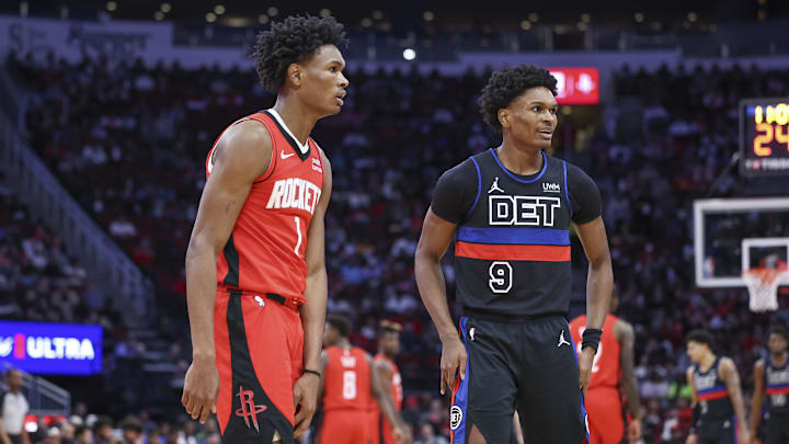 Jan 1, 2024; Houston, Texas, USA; Houston Rockets forward Amen Thompson (1) and Detroit Pistons forward Ausar Thompson (9) on the court during the game at Toyota Center. Mandatory Credit: Troy Taormina-Imagn Images