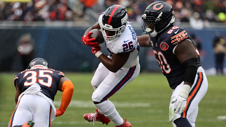 Nov 9, 2025; Chicago, Illinois, USA; New York Giants running back Devin Singletary (26) rushes the ball against Chicago Bears defensive tackle Grady Jarrett (50) during the second half at Soldier Field. Mandatory Credit: Mike Dinovo-Imagn Images