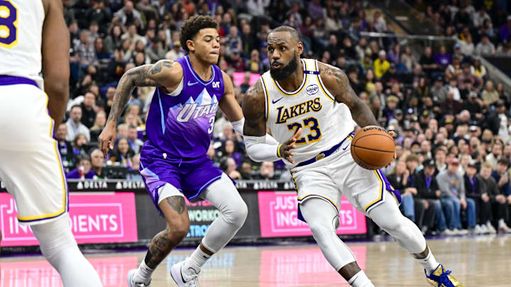 Dec 1, 2024; Salt Lake City, Utah, USA; Los Angeles Lakers forward LeBron James (23) drives towards the basket around Utah Jazz guard Keyonte George (3) during the second half at the Delta Center. Mandatory Credit: Christopher Creveling-Imagn Images