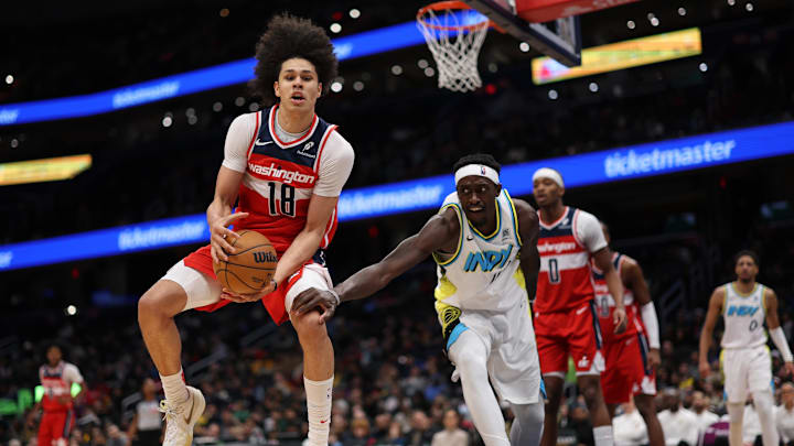 Feb 12, 2025; Washington, District of Columbia, USA; Washington Wizards forward Kyshawn George (18) grabs a loose ball in front ofIndiana Pacers forward Pascal Siakam (43) in the third quarter at Capital One Arena. Mandatory Credit: Geoff Burke-Imagn Images