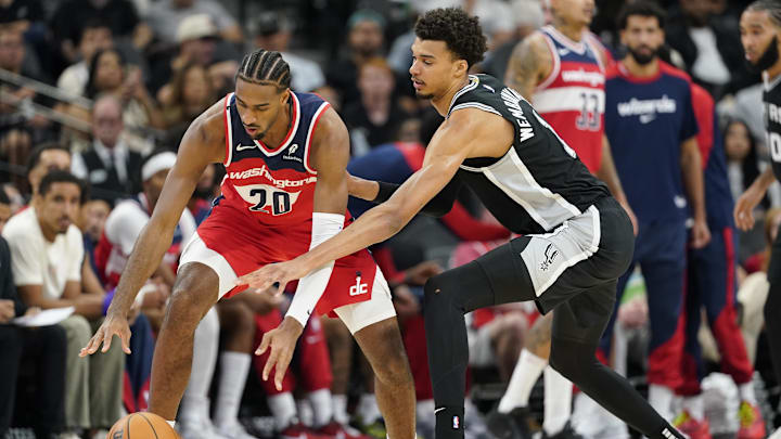Nov 13, 2024; San Antonio, Texas, USA; San Antonio Spurs center Victor Wembanyama (1) reaches for the ball while defending Washington Wizards forward Alex Sarr (20) during the first half at Frost Bank Center. Mandatory Credit: Scott Wachter-Imagn Images