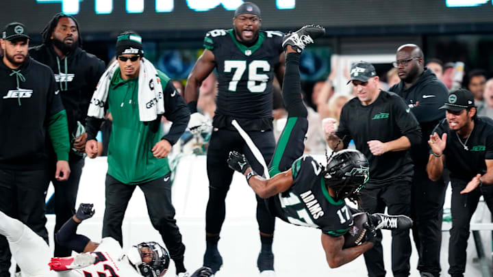 After completing a catch New York Jets wide receiver Davante Adams (17) flipped in the air after colliding with Houston Texans safety Eric Murray (23), Thursday, October 31, 2024, in East Rutherford. The completed pass set the Jets up for a touchdown.