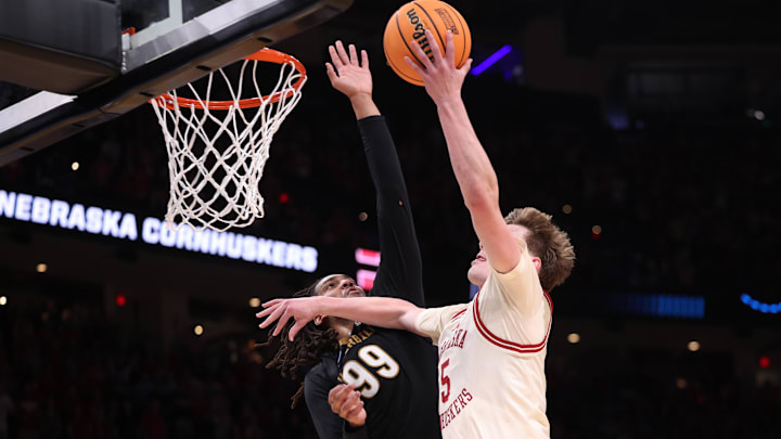 Mar 21, 2026; Oklahoma City, OK, USA; Nebraska Cornhuskers forward Braden Frager (5) drives to the hoop past Vanderbilt Commodores forward Devin McGlockton (99) during the second half of a second round game of the men's 2026 NCAA Tournament at Paycom Center. Mandatory Credit: William Purnell-Imagn Images