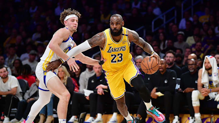Apr 3, 2025; Los Angeles, California, USA; Los Angeles Lakers forward LeBron James (23) moves to the basket against Golden State Warriors guard Brandin Podziemski (2) during the first half at Crypto.com Arena. Mandatory Credit: Gary A. Vasquez-Imagn Images