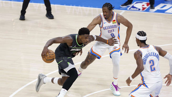 May 20, 2025; Oklahoma City, Oklahoma, USA; Minnesota Timberwolves guard Anthony Edwards (5) drives against Oklahoma City Thunder forward Jalen Williams (8) and guard Shai Gilgeous-Alexander (2) in the third quarter during game one of the western conference finals for the 2025 NBA Playoffs at Paycom Center. Mandatory Credit: Alonzo Adams-Imagn Images