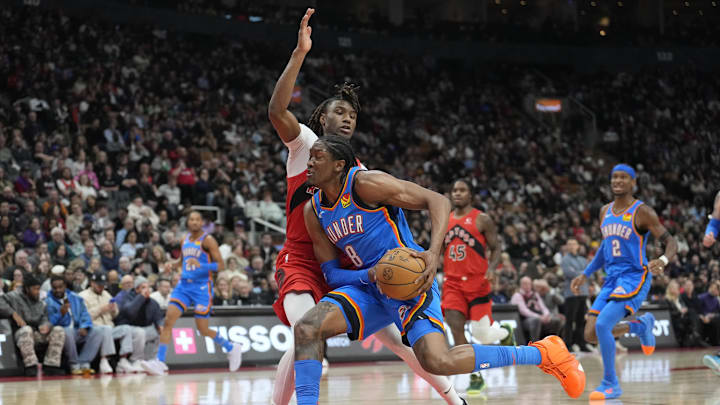 Dec 5, 2024; Toronto, Ontario, CAN; Oklahoma City Thunder forward Jalen Williams (8) drives to the net against Toronto Raptors guard Ja'Kobe Walter (14)  during the second half at Scotiabank Arena. Mandatory Credit: John E. Sokolowski-Imagn Images